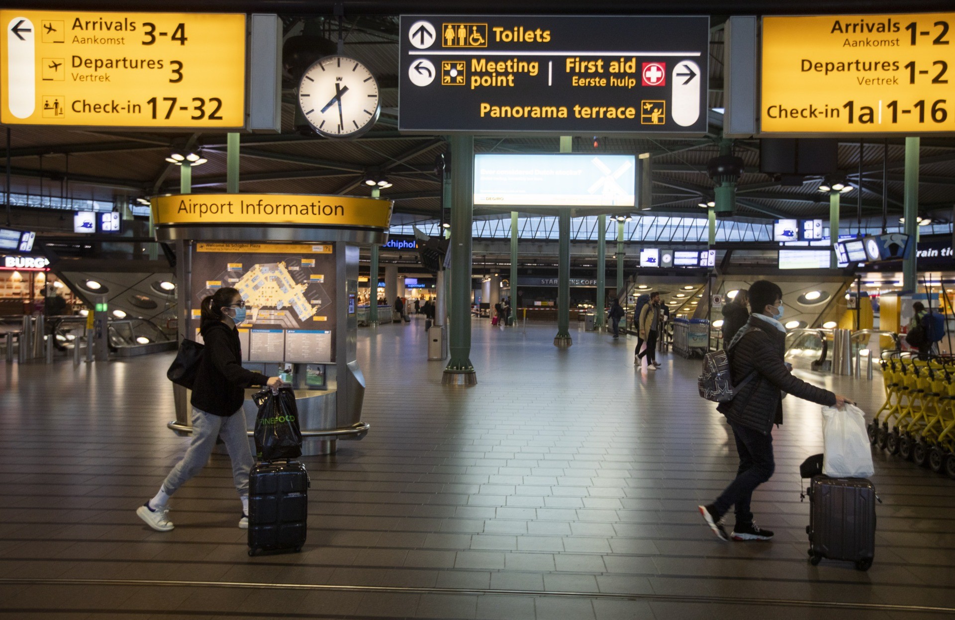 virus outbreak netherlands schiphol file photo dated thursday march 19 2020 travellers wearing
