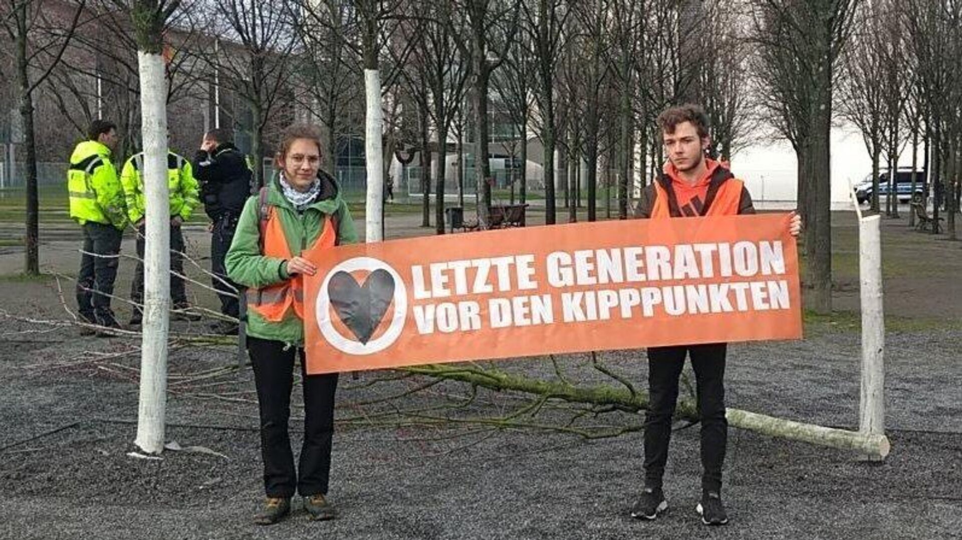 Activists cut down a tree in front of German Chancellor Scholzs office