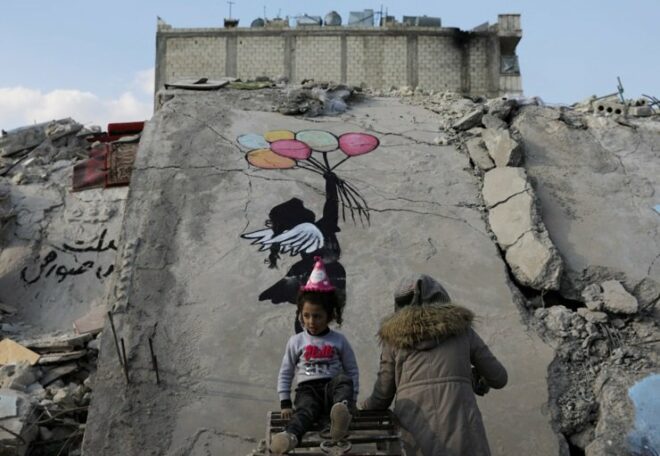 Graffiti artists paint the wreckage of houses destroyed in the earthquake 1 1