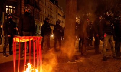 Protesters in France set city hall on fire
