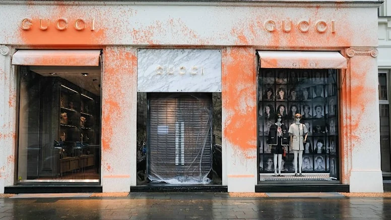 Painted attack from environmental activists on luxury brands like Gucci Rolex and Prada