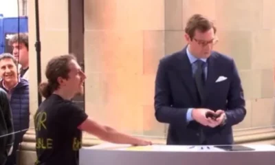 Climate activist stuck his hand on the podium where the presenter was on live broadcast